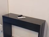 a black table with a tv on it in a room