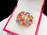 a colorful ring in a red box on a white plate