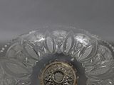 a clear glass bowl with a decorative design on it
