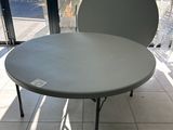 a table that has a chair on it in front of a window