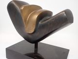 bronze sculpture of a bird on a black base on a white background