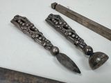 two old metal objects are sitting on a table next to each other