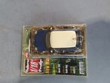 a small toy car in a plastic box on a table