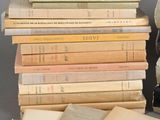 many books stacked on top of each other on a table