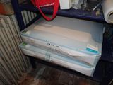 a blue shelf with a red bag on top of it
