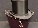 a black top hat sitting on top of a purple container