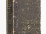 an old book sitting on top of a table next to a white background