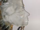 a close up of a glass sculpture of a woman ' s face