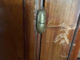 a close up of a wooden cabinet with a door handle
