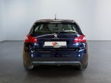 a blue car that is parked in a room