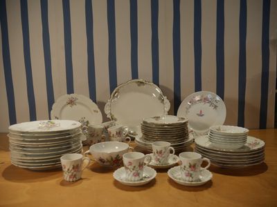 a lot of plates and cups on the table