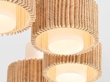 three lamps made out of cardboard are hanging from a wall