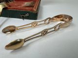 two spoons and a fork sitting on a table