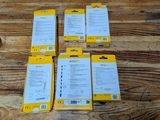 four packages of yellow and white paper sitting on a wooden table