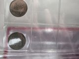 two coins in a clear plastic box on a table