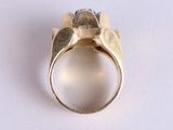 an image of a gold ring on a white surface