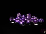 purple amethorate gems on a black background
