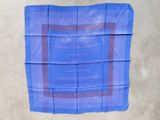 a close up of a blue handkerchief with a brown border