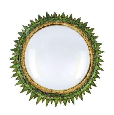 a close up of a mirror on a white background with green leaves