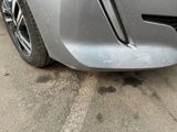 a close up of a car ' s front bumper with scratches