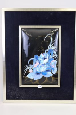 painting of a blue flower in a black frame on a white surface