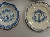 three blue and white plates are sitting on a table