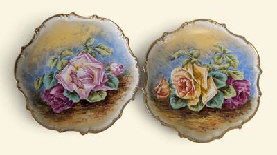 deux assiettes sur lesquelles sont peintes des fleurs sur un fond blanc