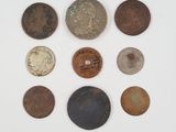 several different types of coins are arranged on a white surface