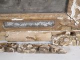 a picture of a broken window frame and some rocks