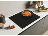 an image of a stove top with a bowl of food on top of it