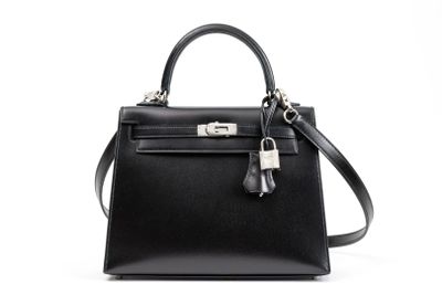 a black leather handbag on a white background