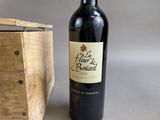 a bottle of wine sitting next to a wooden box