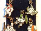 five charms of a mummy and a man with a surfboard on a black case