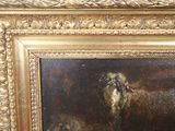 a painting of a dog and a cat in a gold frame