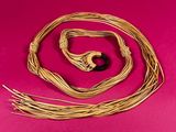 a close up of a rope with a black bead on it