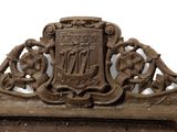 an old mirror with a coat of arms and a coat of arms on it