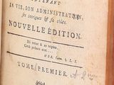 an old book with writing on it sitting on a table
