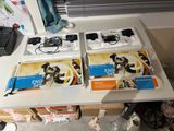 four boxes of wii game controllers on a table