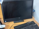 a computer monitor and keyboard on a desk