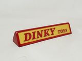 a red and yellow sign that says dinky toys