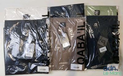 four pairs of men ' s t - shirts in plastic bags on a table
