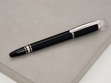 a pen that is laying on top of a book