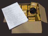 a box with a lot of items in it and a piece of paper on top of it