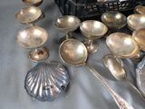 a lot of silver spoons and other silverware on a table