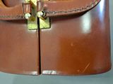 a brown leather bag with a gold buckle on it