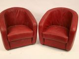pair of red leather swivel chairs on white background