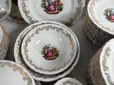 a lot of plates and cups that are on a table