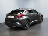 the rear end of a gray toyota c - hr in a showroom