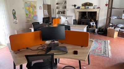 an image of a home office with a desk and two monitors