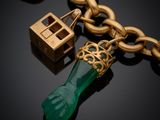 an image of a close up of a key chain with a green object on it